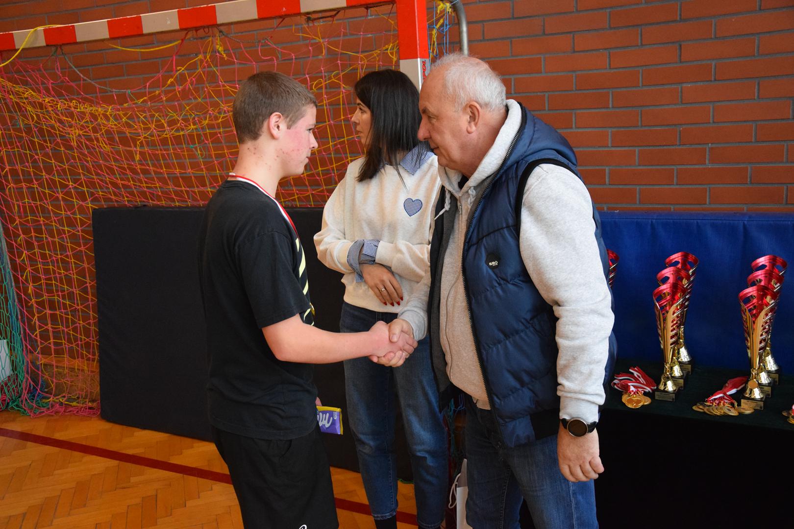 Zdjęcie przedstawia moment wręczania medali, dyplomów i pucharów