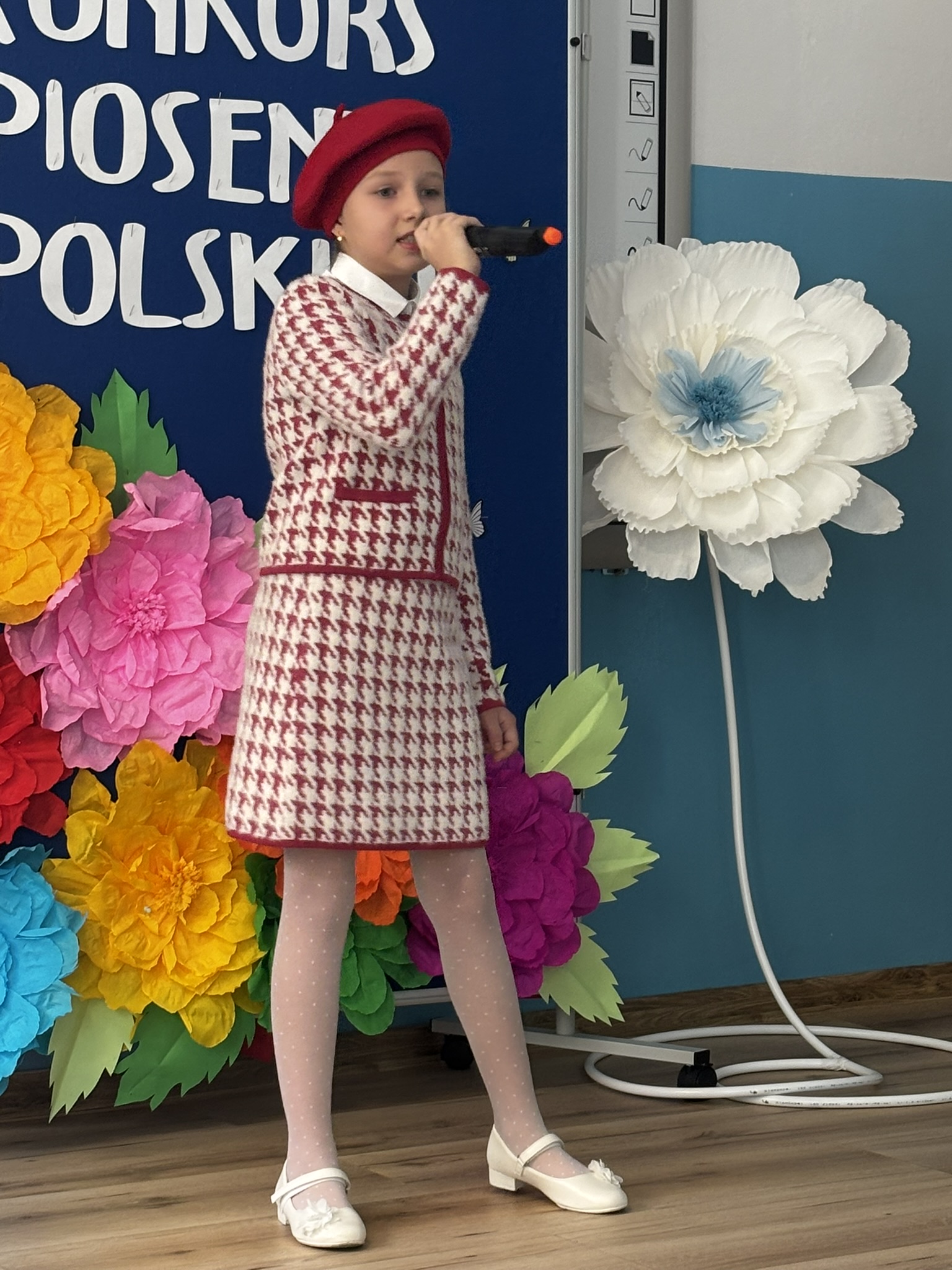 Zdjęcie przedstawia uczestnika konkursu wokalnego w&nbsp;trakcie występu